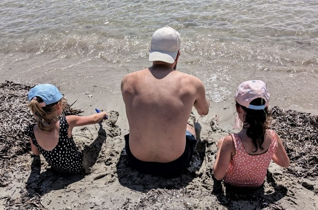 Liam with his daughters on the beach